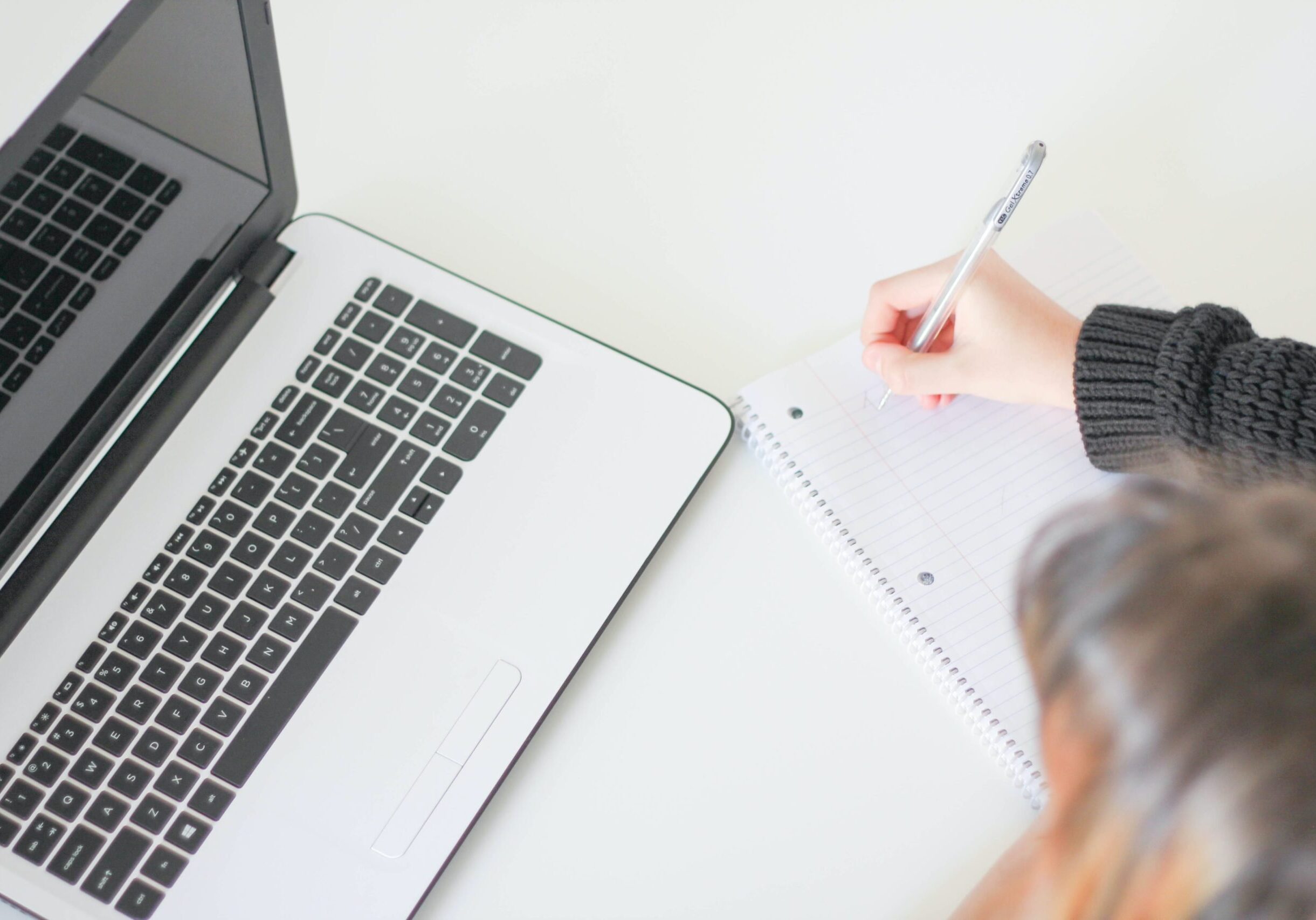 laptop and writing in notebook